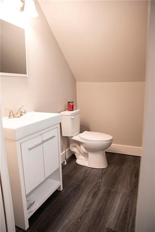 121 Pear St, Chippewa Falls, WI 54729 - half bath featuring lofted ceiling, toilet, wood finished floors, vanity, and baseboards