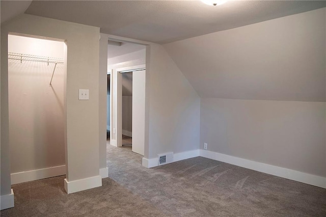 121 Pear St, Chippewa Falls, WI 54729 - additional living space featuring carpet floors, vaulted ceiling, and baseboards