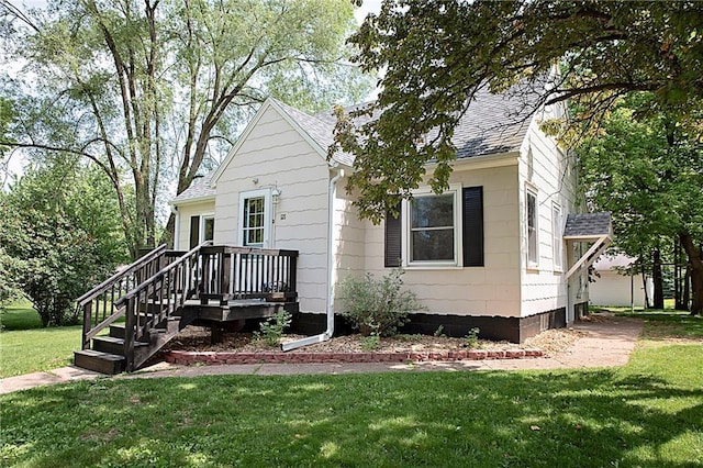 121 Pear St, Chippewa Falls, WI 54729 - view of front of property featuring a shingled roof and a front lawn