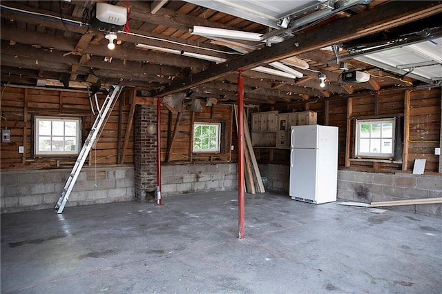 121 Pear St, Chippewa Falls, WI 54729 - garage featuring freestanding refrigerator and a garage door opener