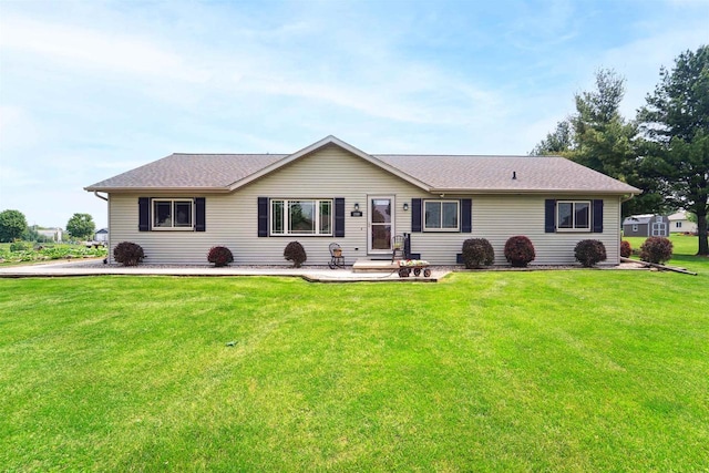 249 Donovan Cir, Rosendale, WI 54974 - view of front facade featuring a front yard, a shingled roof, and a patio area