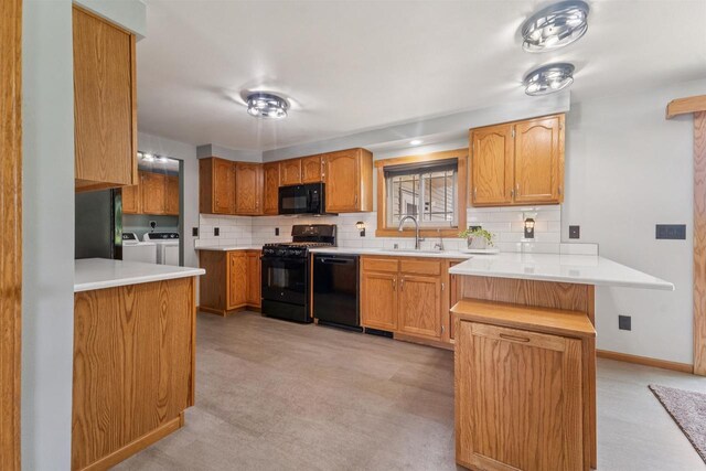 249 Donovan Cir, Rosendale, WI 54974 - kitchen with black appliances, independent washer and dryer, a sink, and light carpet