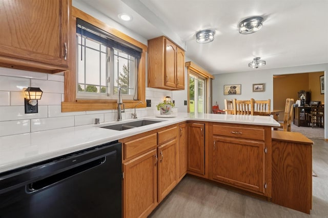 249 Donovan Cir, Rosendale, WI 54974 - kitchen with dishwasher, a sink, a peninsula, backsplash, and light countertops