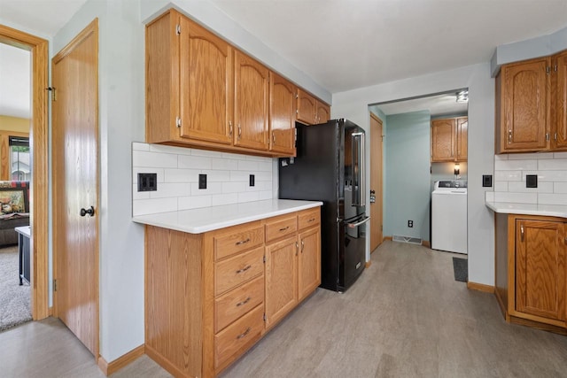 249 Donovan Cir, Rosendale, WI 54974 - kitchen featuring washer / dryer, freestanding refrigerator, decorative backsplash, light countertops, and baseboards