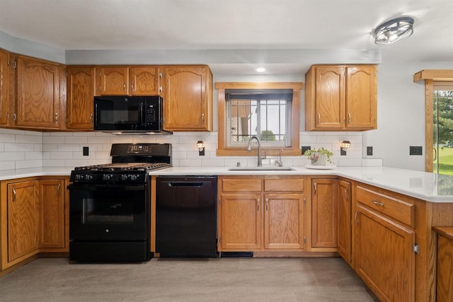 249 Donovan Cir, Rosendale, WI 54974 - kitchen with black appliances, a sink, light countertops, brown cabinetry, and recessed lighting