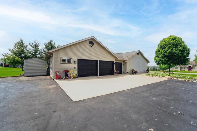 249 Donovan Cir, Rosendale, WI 54974 - view of front of home with driveway, a garage, and an outbuilding