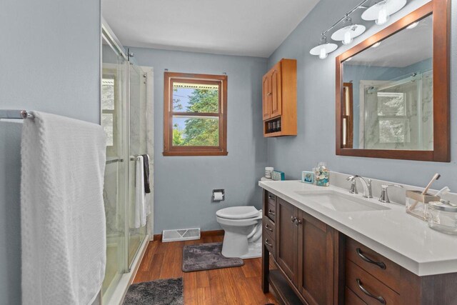 1636 S Driscoll St, Appleton, WI 54914 - full bath with vanity, toilet, a stall shower, and wood finished floors