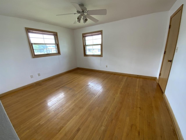 874 E Petunia Ln, Beloit, WI 53511 - empty room featuring plenty of natural light, light wood-style flooring, and ceiling fan