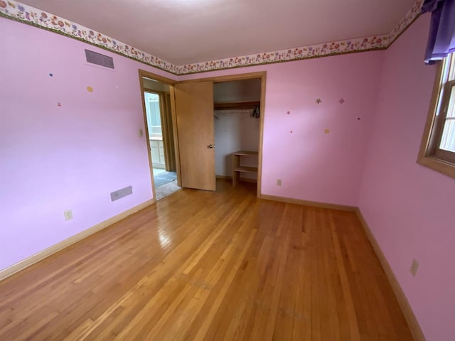 874 E Petunia Ln, Beloit, WI 53511 - unfurnished bedroom with light wood finished floors and a closet