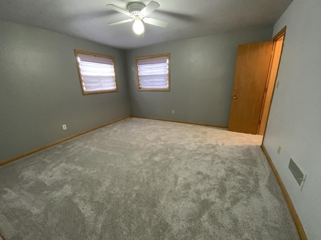 874 E Petunia Ln, Beloit, WI 53511 - carpeted empty room featuring a ceiling fan and baseboards