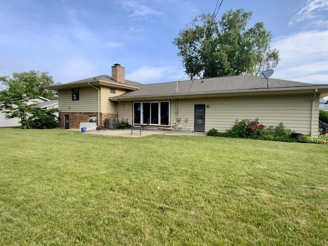 874 E Petunia Ln, Beloit, WI 53511 - back of property with a chimney, a patio, a yard, and brick siding