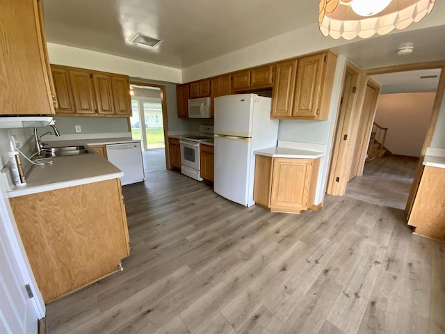 874 E Petunia Ln, Beloit, WI 53511 - kitchen with white appliances, light wood-style floors, and light countertops
