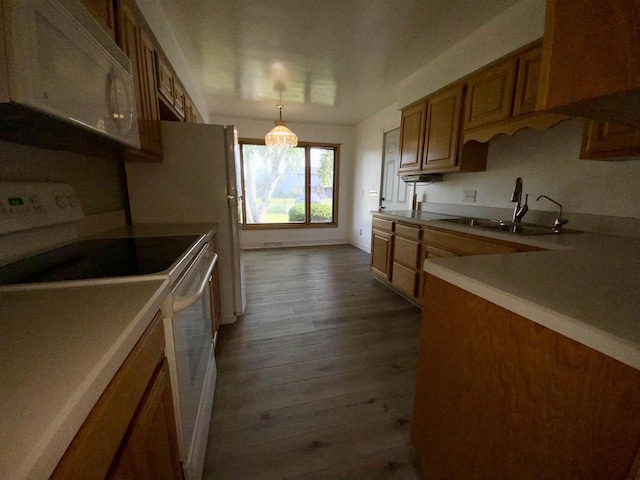 874 E Petunia Ln, Beloit, WI 53511 - kitchen with white appliances, dark wood-style flooring, brown cabinetry, light countertops, and pendant lighting