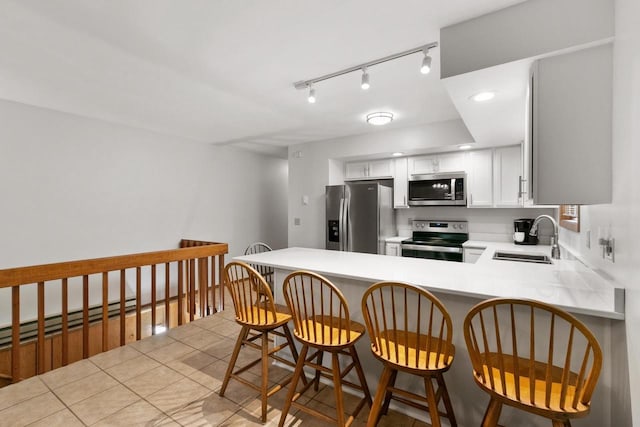 1251 Canyon Rd Unit 40, Wisconsin Dells, WI 53965 - kitchen with stainless steel appliances, a sink, a peninsula, light countertops, and white cabinets