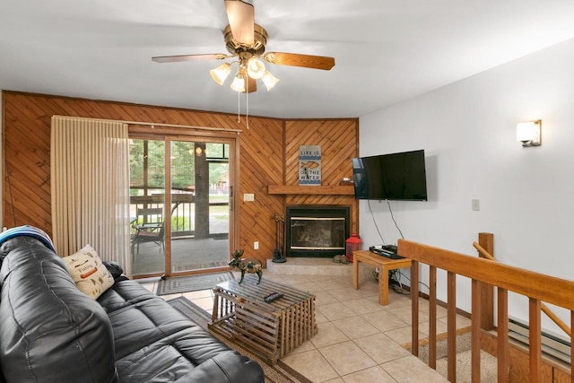 1251 Canyon Rd Unit 40, Wisconsin Dells, WI 53965 - living area with wooden walls, light tile patterned floors, a ceiling fan, a tile fireplace, and a baseboard radiator