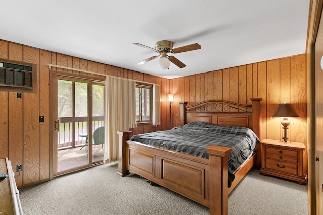 1251 Canyon Rd Unit 40, Wisconsin Dells, WI 53965 - bedroom with access to exterior, light carpet, a wall unit AC, wood walls, and ceiling fan