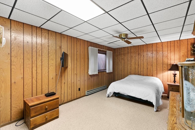 1251 Canyon Rd Unit 40, Wisconsin Dells, WI 53965 - carpeted bedroom with a baseboard heating unit, a paneled ceiling, wood walls, and ceiling fan