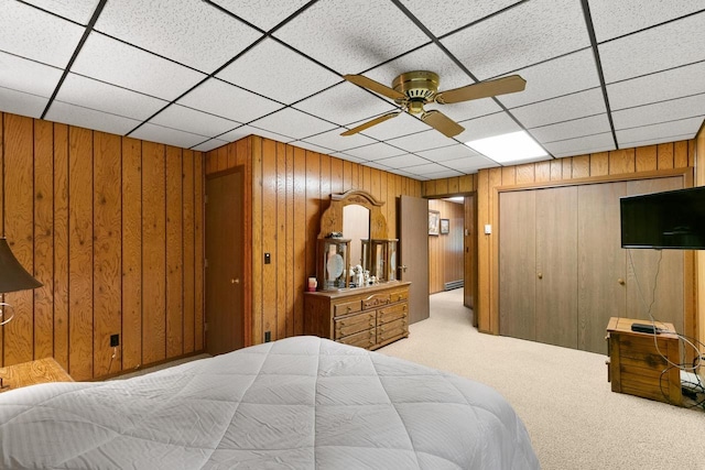 1251 Canyon Rd Unit 40, Wisconsin Dells, WI 53965 - bedroom featuring wood walls, light carpet, a closet, ceiling fan, and a paneled ceiling