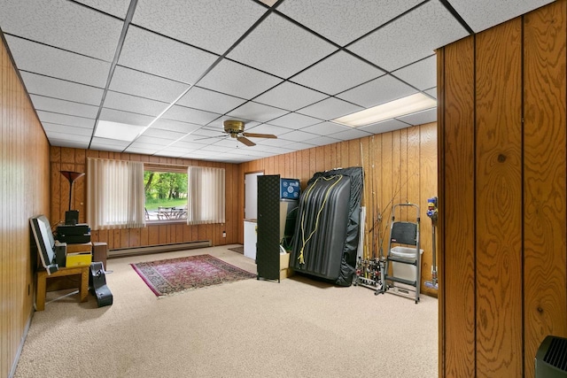 1251 Canyon Rd Unit 40, Wisconsin Dells, WI 53965 - exercise area with a baseboard heating unit, carpet floors, wooden walls, ceiling fan, and a paneled ceiling