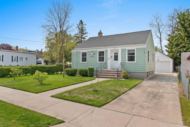 1013 28th St, Two Rivers, WI 54241 - view of front of house featuring a garage, an outdoor structure, a chimney, a front yard, and a shingled roof