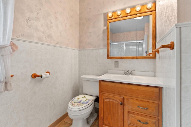 1013 28th St, Two Rivers, WI 54241 - full bathroom featuring toilet, vanity, wainscoting, wallpapered walls, and tile walls