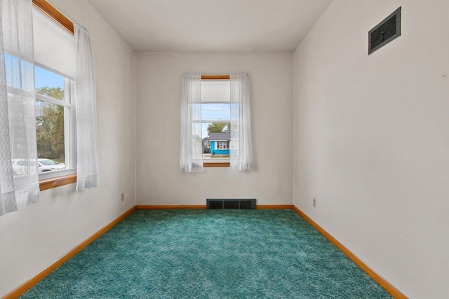 1013 28th St, Two Rivers, WI 54241 - carpeted empty room featuring healthy amount of natural light and baseboards