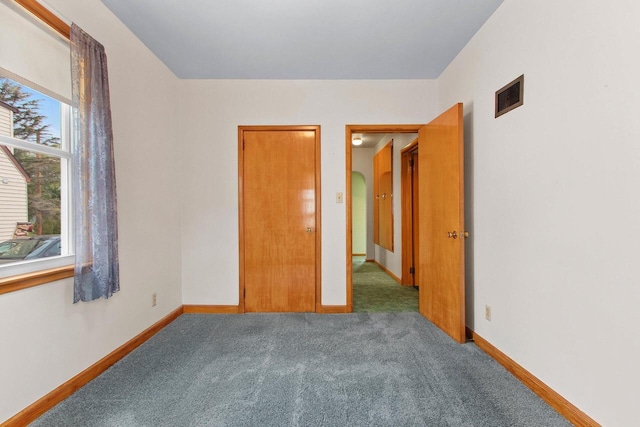 1013 28th St, Two Rivers, WI 54241 - unfurnished bedroom with carpet flooring and baseboards