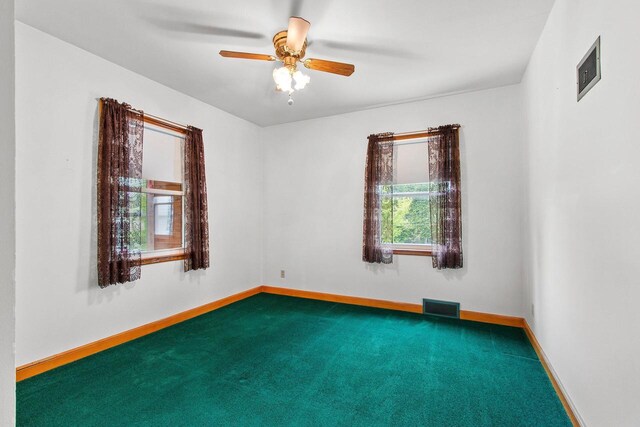 1013 28th St, Two Rivers, WI 54241 - spare room featuring carpet flooring, a ceiling fan, and baseboards