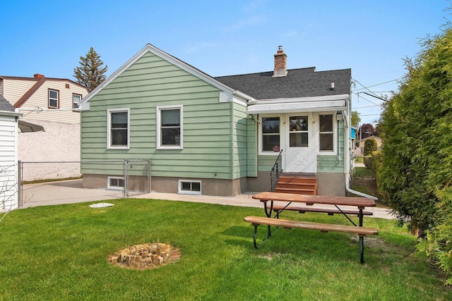 1013 28th St, Two Rivers, WI 54241 - back of property featuring a lawn, roof with shingles, a chimney, and entry steps