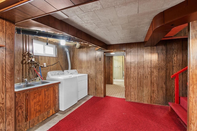 1013 28th St, Two Rivers, WI 54241 - basement featuring washing machine and dryer, wooden walls, a sink, carpet floors, and stairs