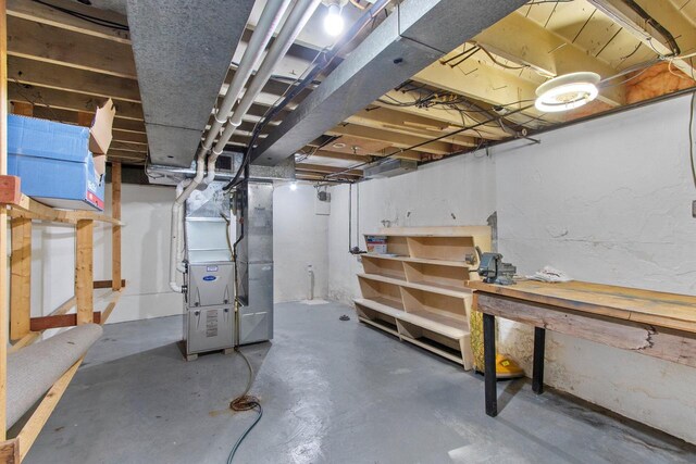 1013 28th St, Two Rivers, WI 54241 - unfinished below grade area featuring heating unit and a workshop area