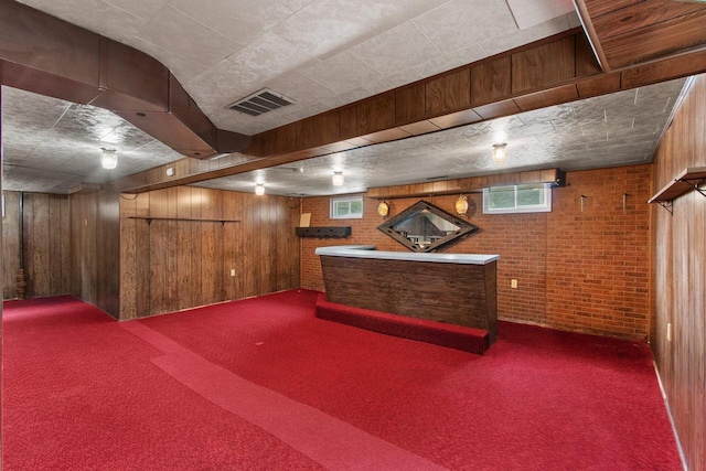 1013 28th St, Two Rivers, WI 54241 - basement with carpet, wood walls, brick wall, and bar