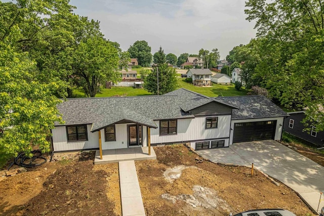 600 8th Ave, New Glarus, WI 53574 - modern inspired farmhouse with roof with shingles, a garage, and driveway