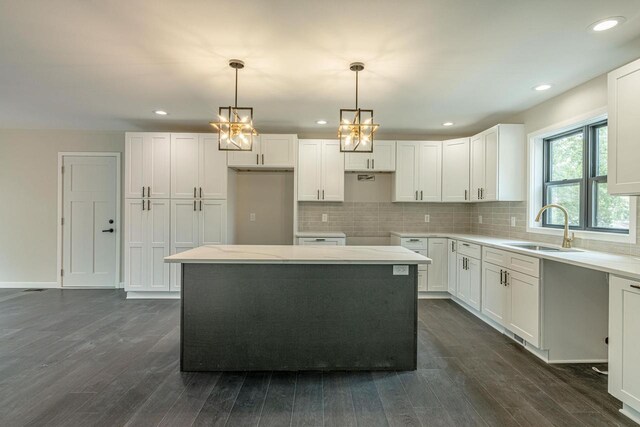 600 8th Ave, New Glarus, WI 53574 - kitchen with a sink, dark wood-style flooring, tasteful backsplash, white cabinetry, and recessed lighting