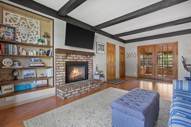 8317 S 42nd St, Franklin, WI 53132 - living room with wood finished floors, french doors, beamed ceiling, and a brick fireplace