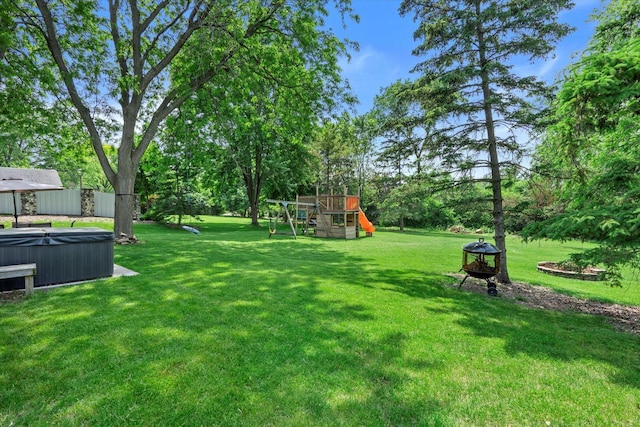 8317 S 42nd St, Franklin, WI 53132 - view of green lawn featuring a hot tub, a playground, and view of scattered trees