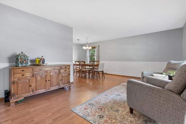 8317 S 42nd St, Franklin, WI 53132 - living room with a chandelier, light wood-style flooring, and wainscoting