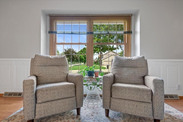 8317 S 42nd St, Franklin, WI 53132 - sitting room featuring wainscoting, a decorative wall, and wood finished floors
