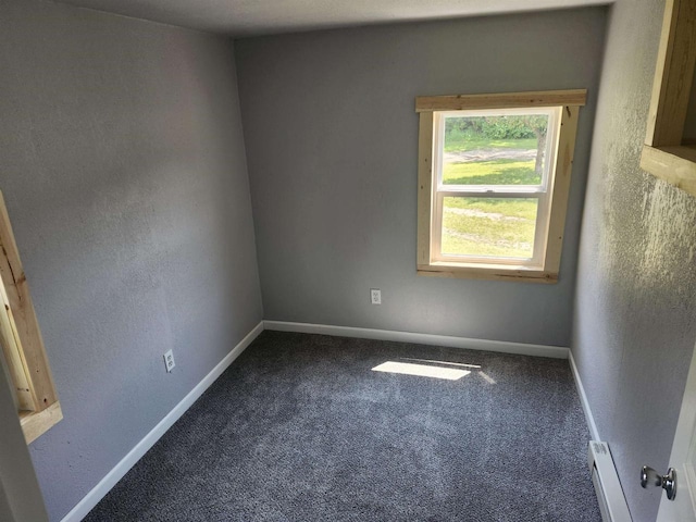 547 S Cambridge St, Wautoma, WI 54982 - carpeted empty room with a baseboard heating unit and baseboards