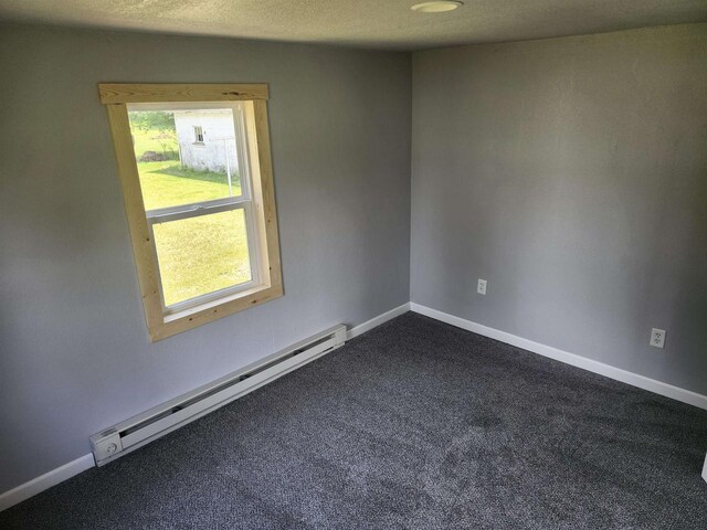 547 S Cambridge St, Wautoma, WI 54982 - unfurnished room with a baseboard heating unit, dark colored carpet, and baseboards
