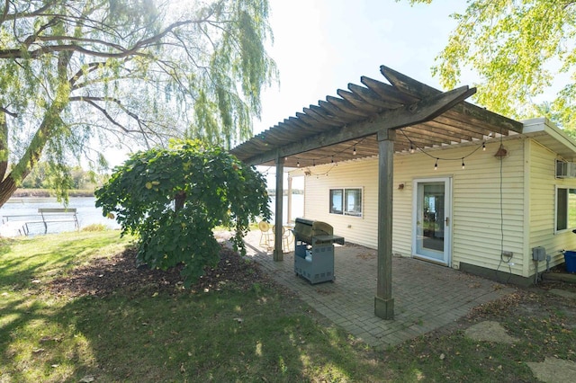 W4943 County Rd S, Horicon, WI 53032 - back of house featuring a pergola, a patio area, and a water view