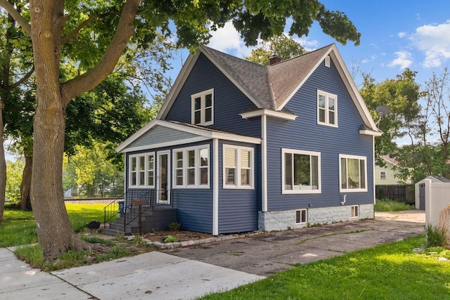 417 E Lincoln Ave, Oshkosh, WI 54901 - view of front of house with a chimney and a shingled roof