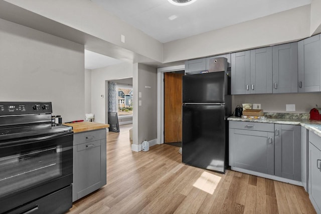 417 E Lincoln Ave, Oshkosh, WI 54901 - kitchen with black appliances, gray cabinetry, light wood-type flooring, and baseboards