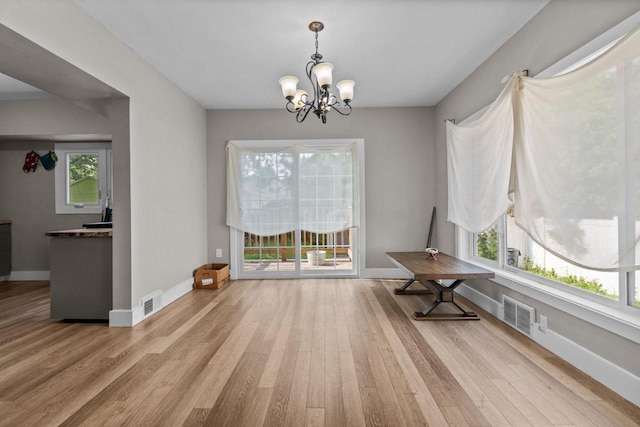 417 E Lincoln Ave, Oshkosh, WI 54901 - dining room with wood finished floors, a chandelier, and baseboards