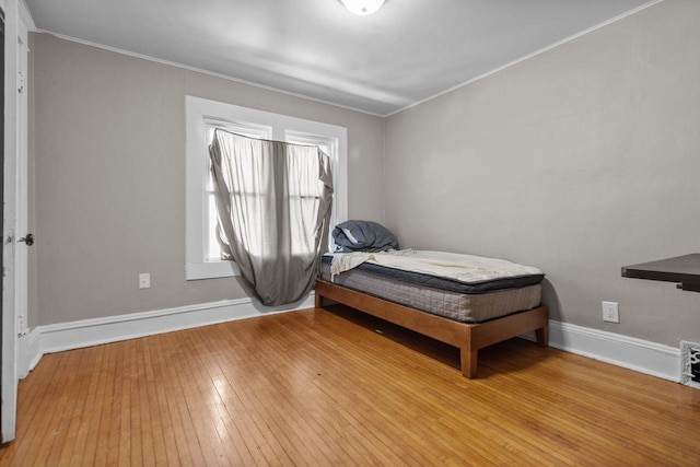 417 E Lincoln Ave, Oshkosh, WI 54901 - bedroom featuring wood-type flooring, ornamental molding, and baseboards