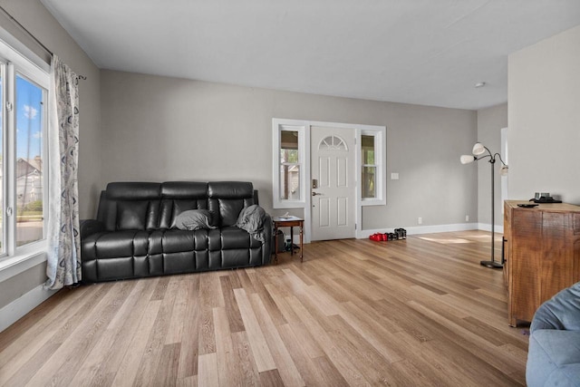 417 E Lincoln Ave, Oshkosh, WI 54901 - living area featuring healthy amount of natural light, light wood-style floors, and baseboards