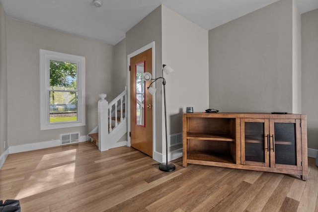 417 E Lincoln Ave, Oshkosh, WI 54901 - entrance foyer with light wood-style floors, baseboards, and stairway