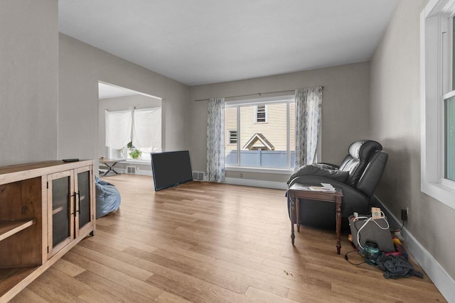 417 E Lincoln Ave, Oshkosh, WI 54901 - living area featuring light wood-type flooring, healthy amount of natural light, and baseboards