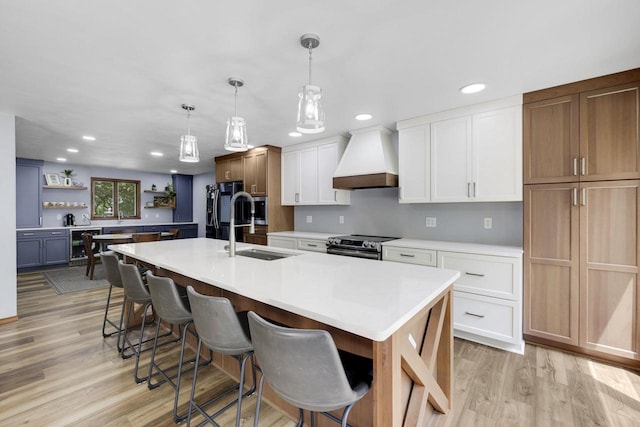 6500 E Decorah Ave, Oshkosh, WI 54902 - kitchen featuring custom range hood, a sink, stainless steel range with electric cooktop, open shelves, and light countertops