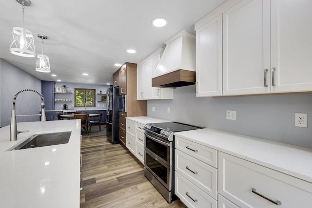 6500 E Decorah Ave, Oshkosh, WI 54902 - kitchen with appliances with stainless steel finishes, custom exhaust hood, a sink, light countertops, and white cabinets
